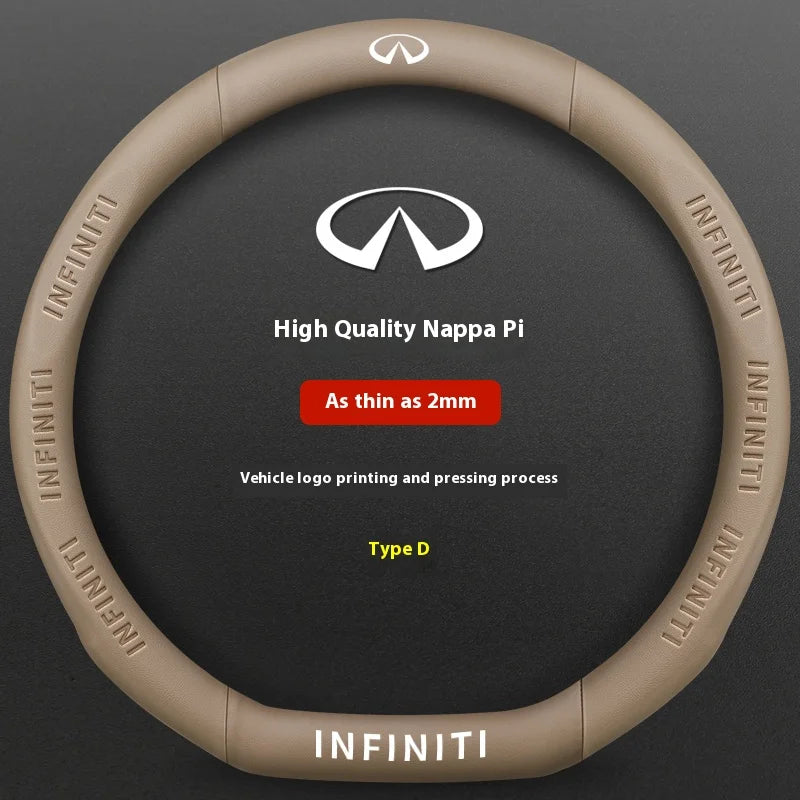 A close-up view of a beige steering wheel cover for an Infiniti vehicle, featuring the Infiniti logo and text.