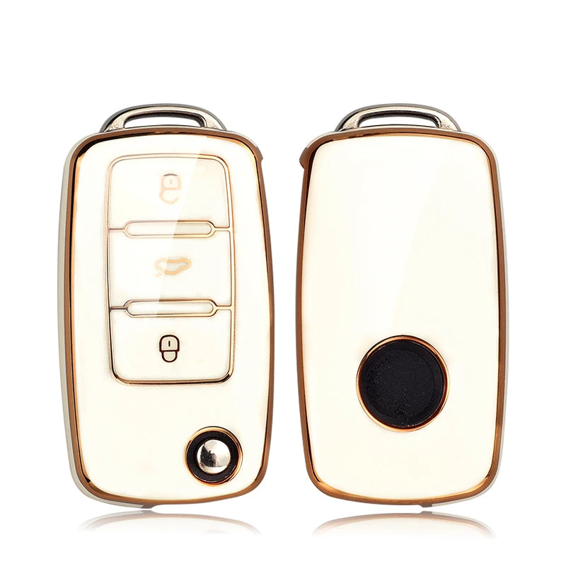 A white TPU car key cover with a gold rim and a black button, shown against a white background.