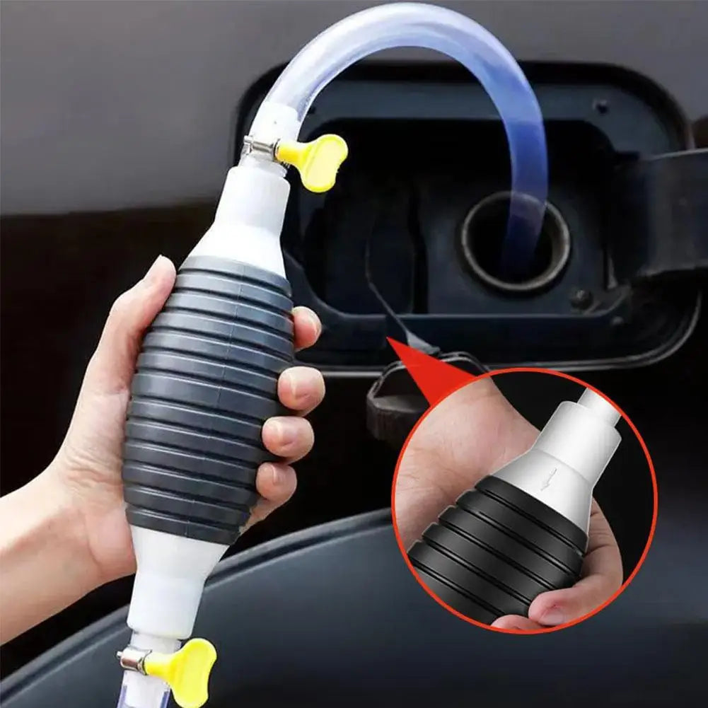 A hand holds a manual liquid transfer pump with a clear tube and yellow connector, demonstrating its use.