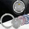 A close-up of a rhinestone car start button cover with a circular design and surrounding rings.