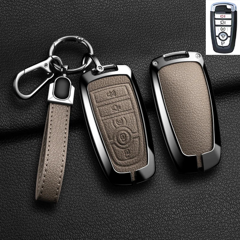 A black aluminum alloy key fob cover with a leather strap and keyring is shown next to the original fob.