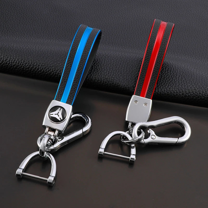 A pair of multi-function key fob holders featuring black and blue striped leather straps and silver metal clasps.