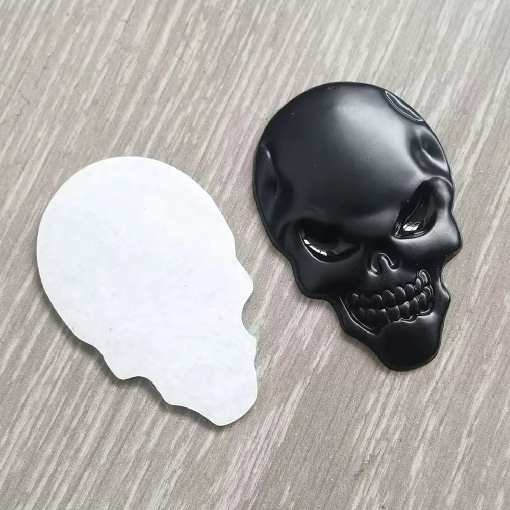A black skull emblem badge is shown next to a white silhouette of a skull on a gray surface.