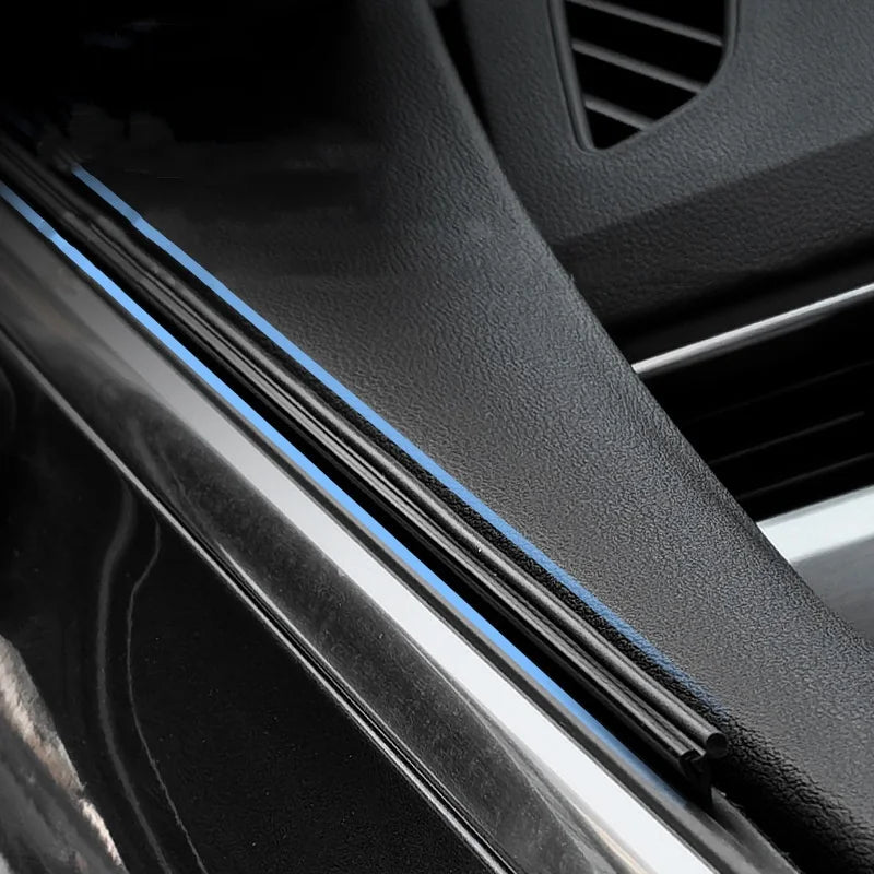 Close-up view of dual car side window wiper blades on a vehicle windshield.