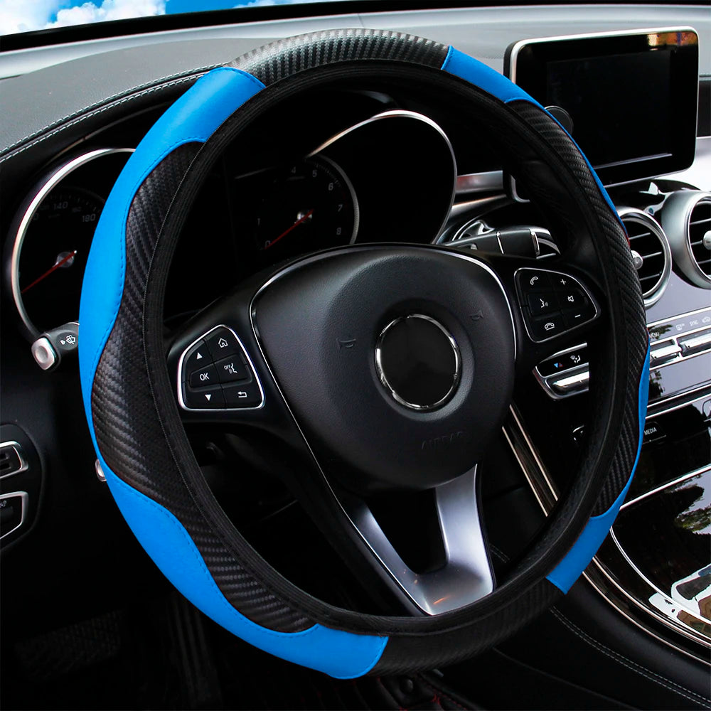 A black steering wheel with a blue accent cover and carbon fiber grip on a car interior.
