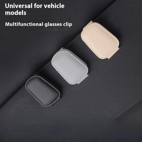 Three magnetic leather sunglasses clips in beige, gray, and dark gray displayed on a dark fabric background.