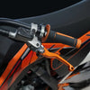 Close-up of precision aluminum brake and clutch levers on an orange off-road bike handlebar.