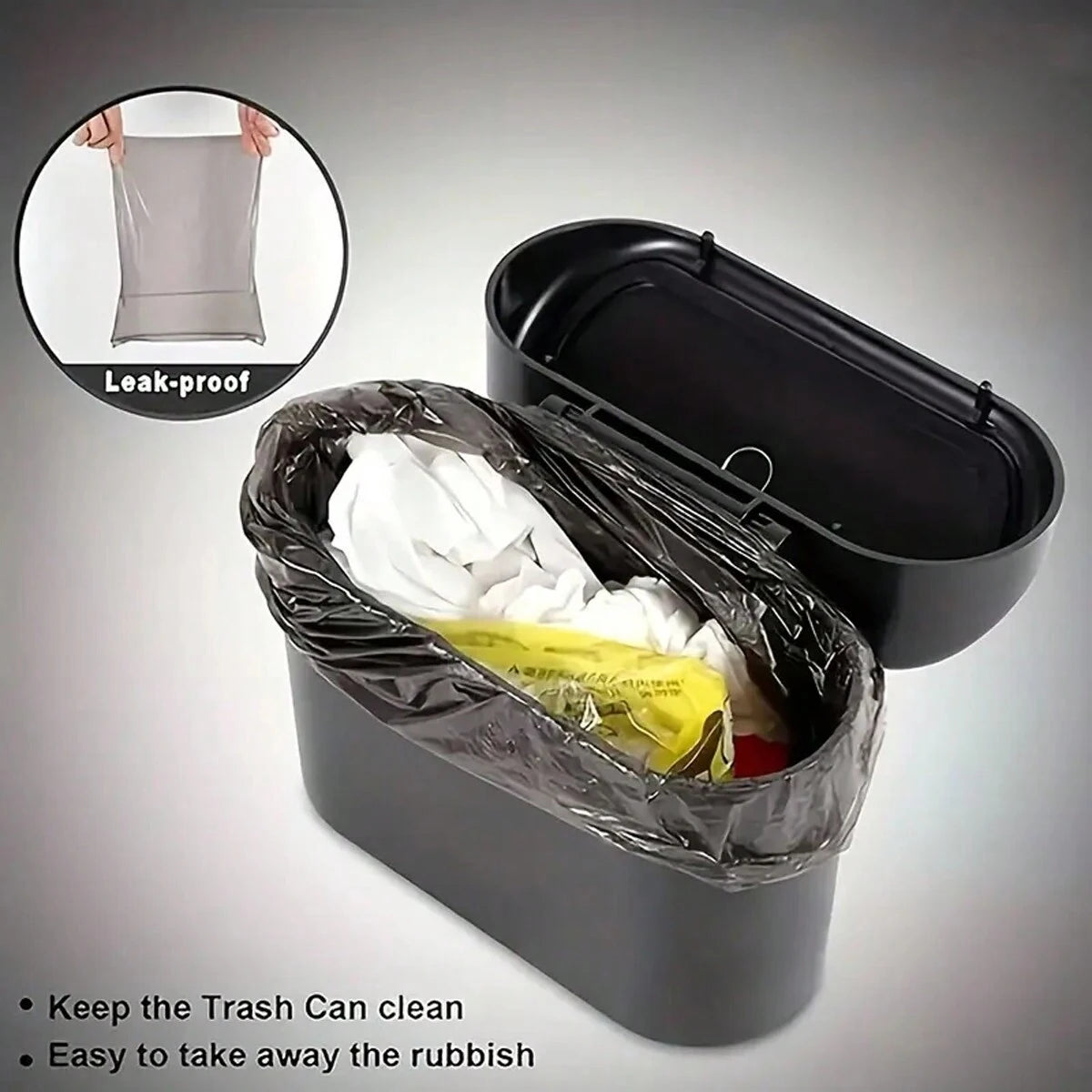 A black portable car trash can with a hanging lid and a leak-proof bag containing rubbish.