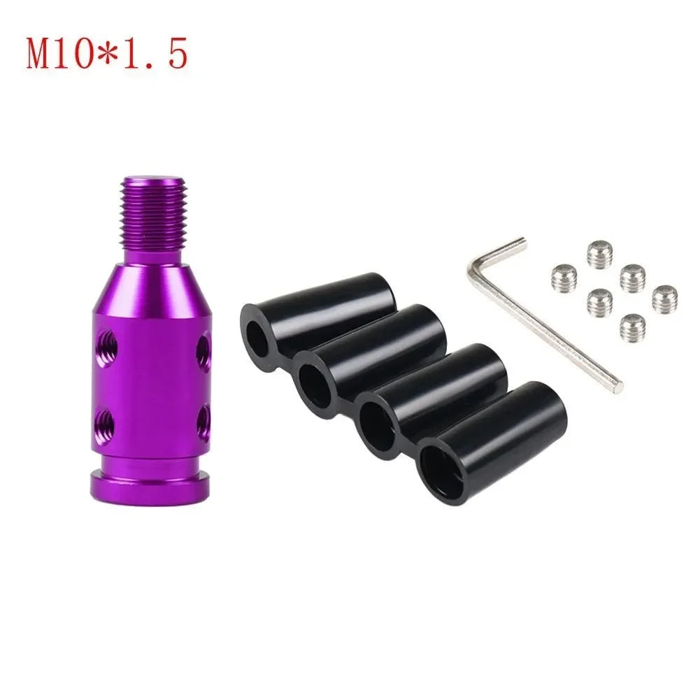 A purple threaded adapter and several black cylindrical components for a gear shift knob.