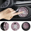 A hand is pressing a rhinestone car start button cover on a vehicle dashboard.