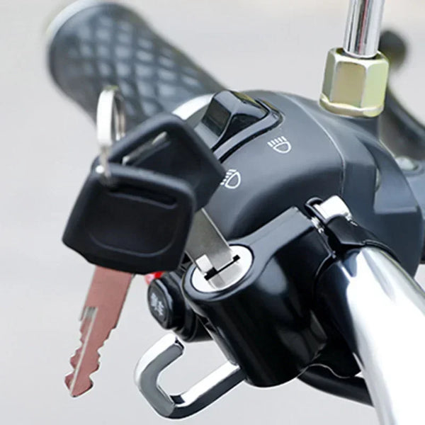 Close-up of a heavy duty anti-theft helmet lock mechanism attached to a motorcycle or bicycle handlebar.