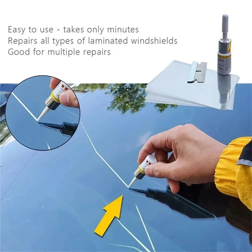 A hand applies a liquid repair kit to a damaged automotive windshield.