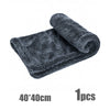 A dark gray, textured microfiber cleaning cloth rolled up, shown against a white background.