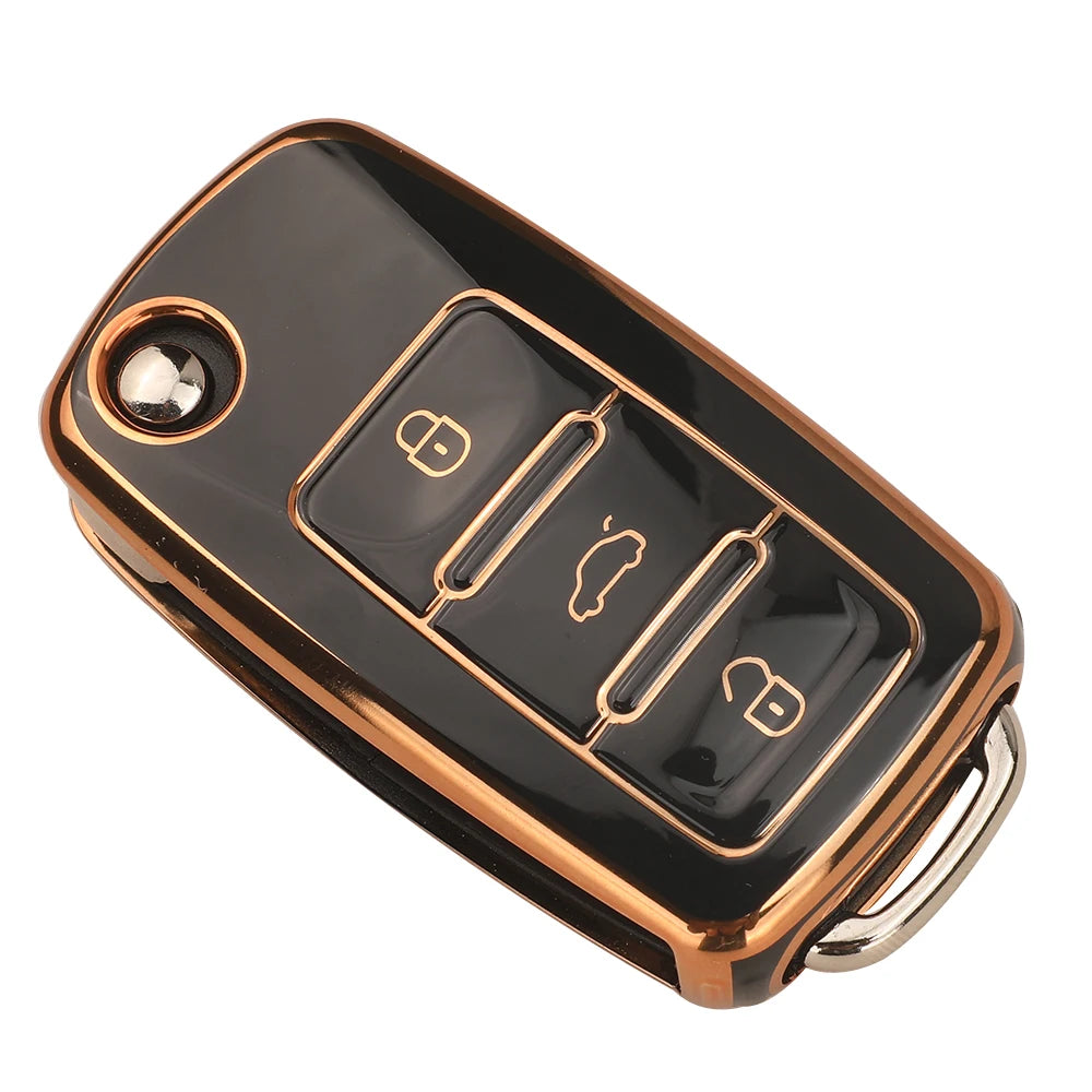 A black silicone TPU car key cover protector with a gold-colored finish and multiple key indentations.