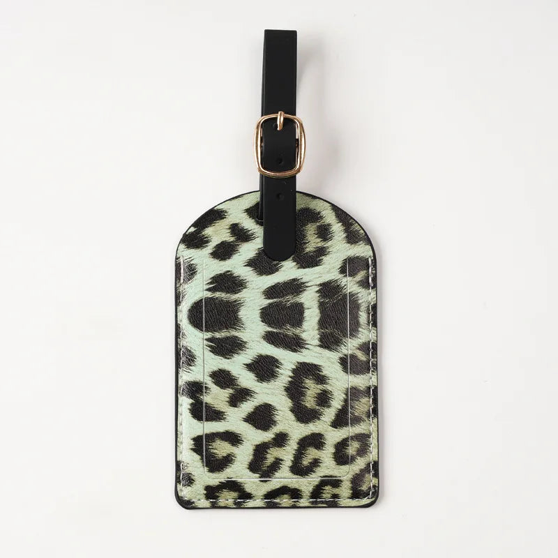 Black leather passport holder with leopard print design and a gold-toned clasp.