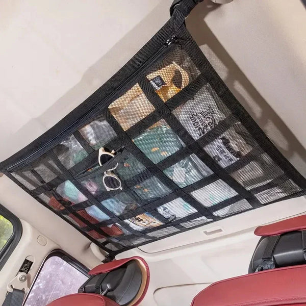 A black heavy-duty cargo net is installed in the interior of a vehicle, covering the cargo area.