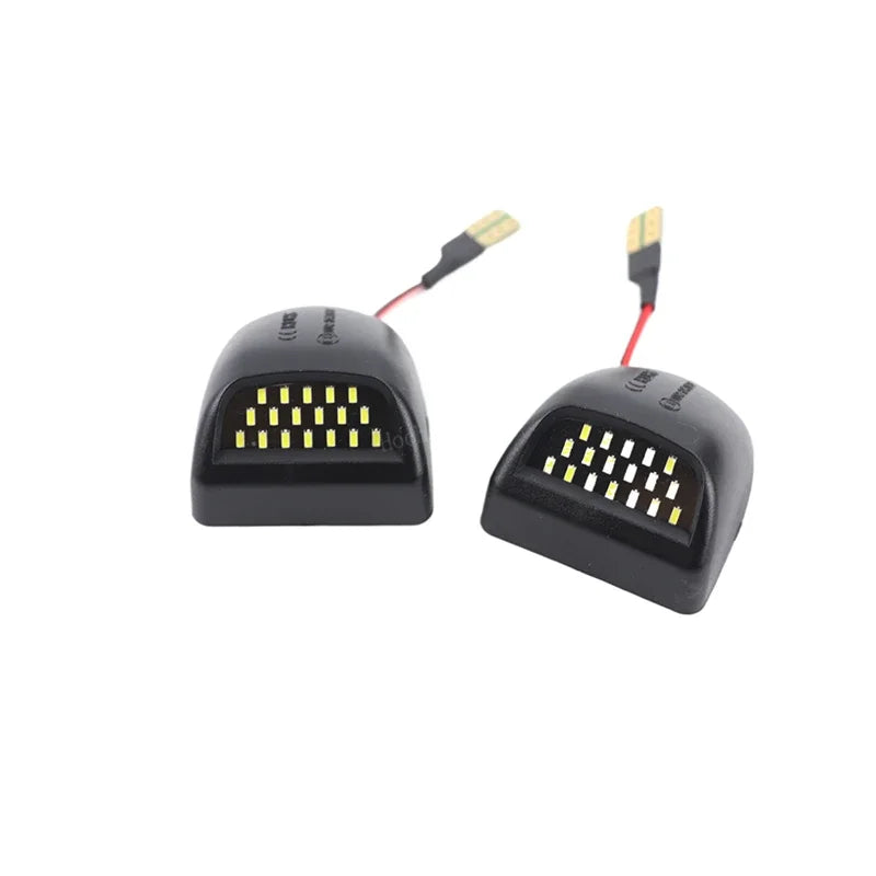 Un par de luces de matrícula LED de alta intensidad con carcasas negras e iluminación amarilla.