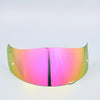 A motorcycle helmet visor with a gradient lens shield showing pink and green colors.