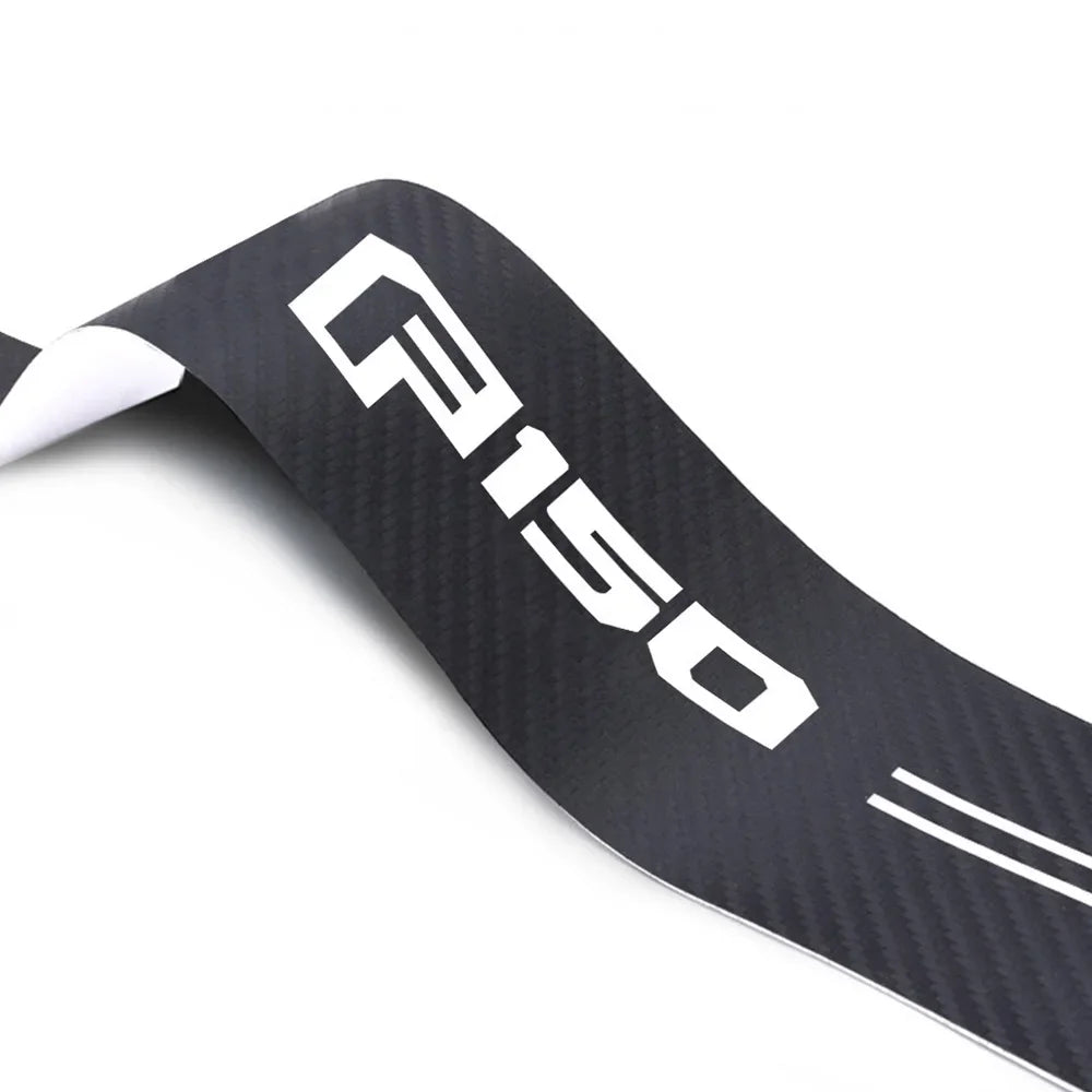 Black carbon fiber door sill protector for a Ford F-150 truck.