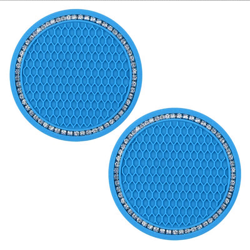A set of bright blue decorative rhinestone car coasters with a hexagonal pattern.
