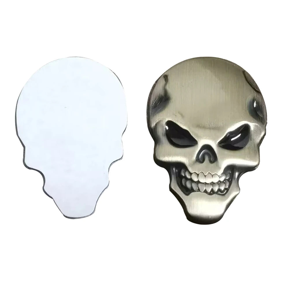 A pair of chrome skull emblem badges, one showing a silhouette and the other a detailed skull.