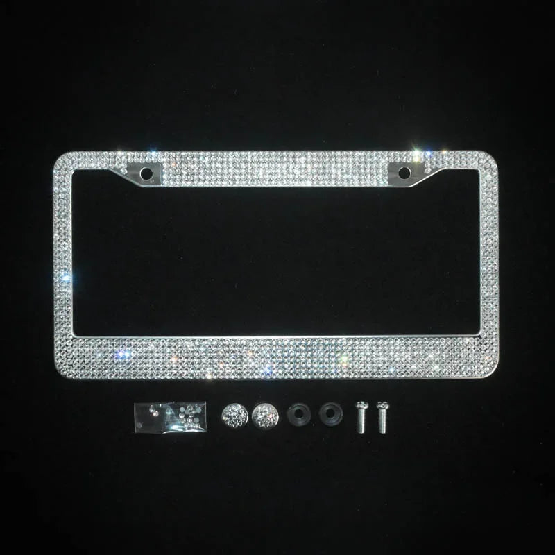 A rectangular license plate frame covered in sparkling crystal rhinestones with mounting tabs.