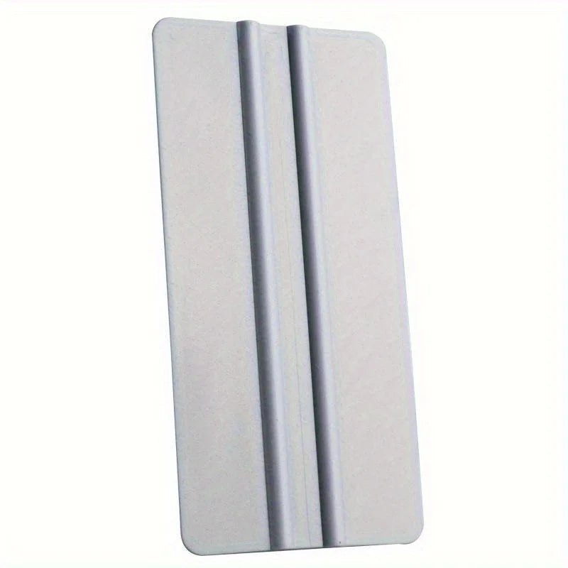 A silver precision scratch-free decal applicator tool with multiple parallel ridges.