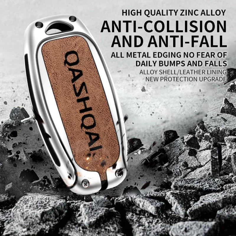 A silver zinc alloy car key cover with a brown textured finish is shown on a pile of dark rocks.