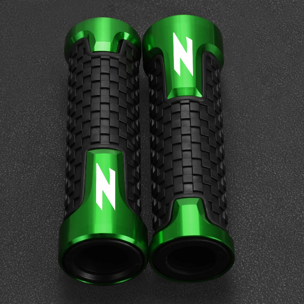 A pair of green and black motorcycle lever and handguard protector set components.