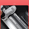 Close-up of a gray car door sill protector installed on the interior trim of a vehicle.