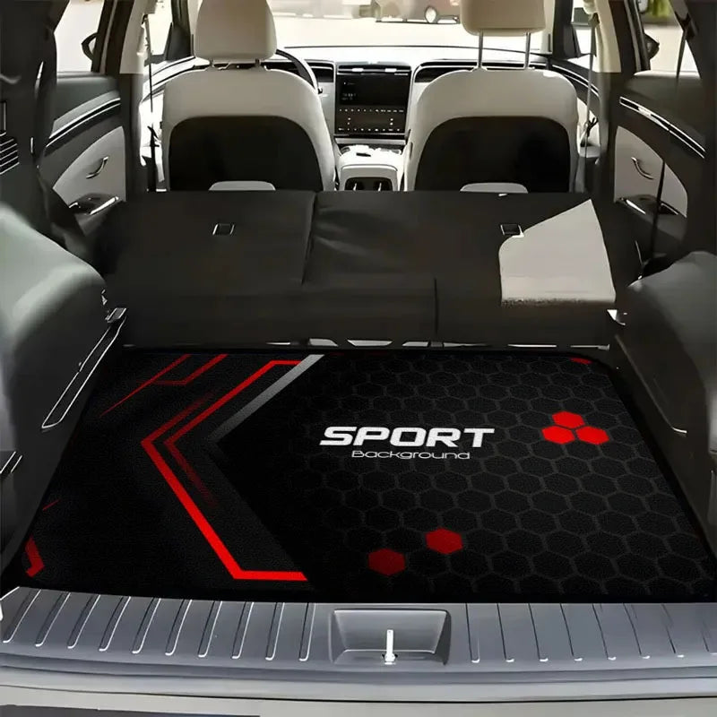 A black car trunk mat with a red sport background and hexagonal pattern is shown inside a vehicle.
