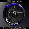 A close-up view of an aftermarket motorcycle wheel featuring blue and white decals on a black rim.