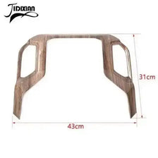 Wooden trim cover for center console navigation panel on Chevy Silverado and GMC Sierra vehicles