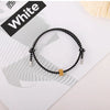 A black heart-shaped fitness tracker bracelet is displayed on a white background with a black label reading White.