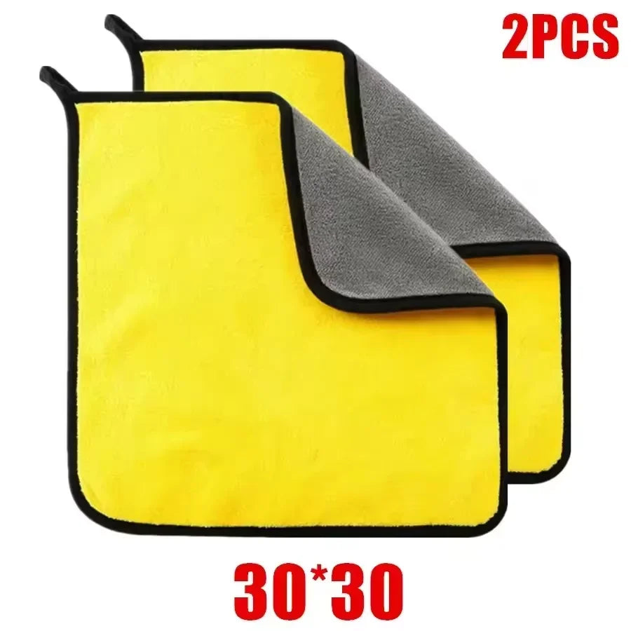 A set of two yellow and gray microfiber car cleaning towels shown in a close-up view.