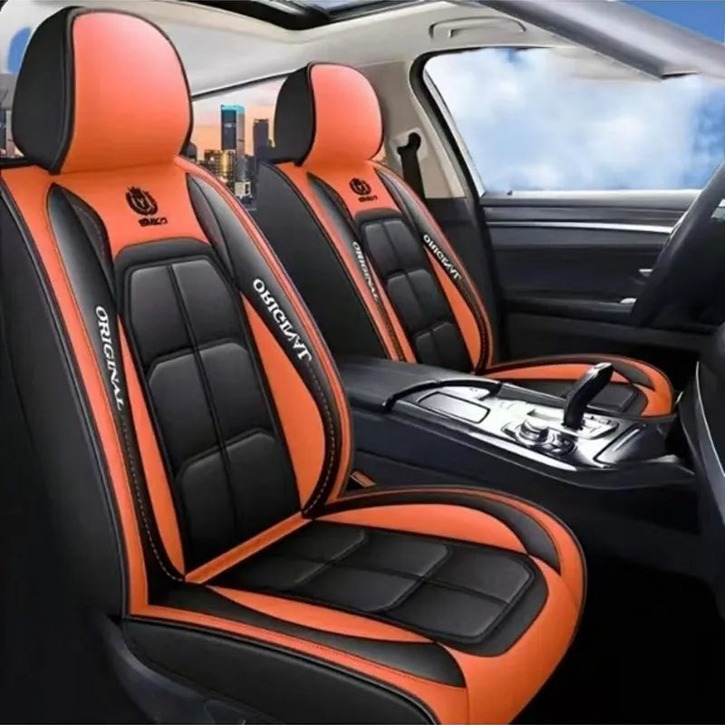 Orange and black leather car seat covers installed in a vehicle interior.