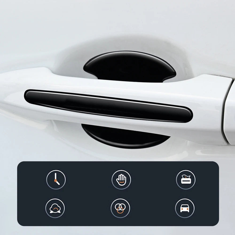 Close-up of a white car door handle with black protection stickers applied to prevent damage.