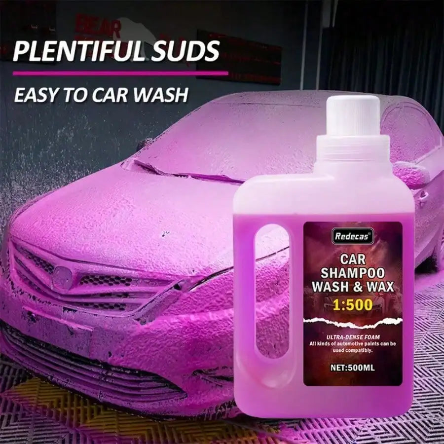 A pink bottle of Redecas car shampoo wash and wax is shown next to a purple car surface.