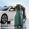 A green high-pressure electric foam spray bottle is positioned in front of a white car.