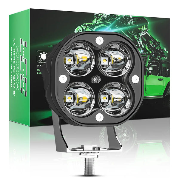 A black high-intensity LED work light with four circular halogen bulbs mounted on a metal bracket, displayed in front of its 