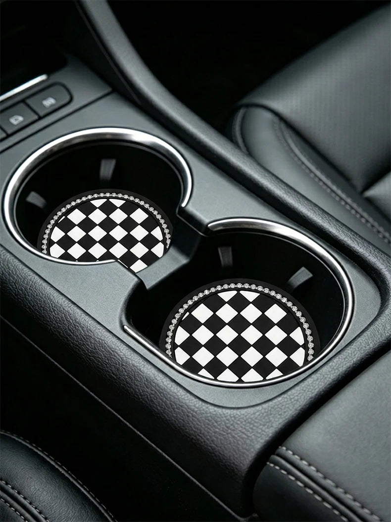Close-up of a black car interior cup holder with two patterned coasters.