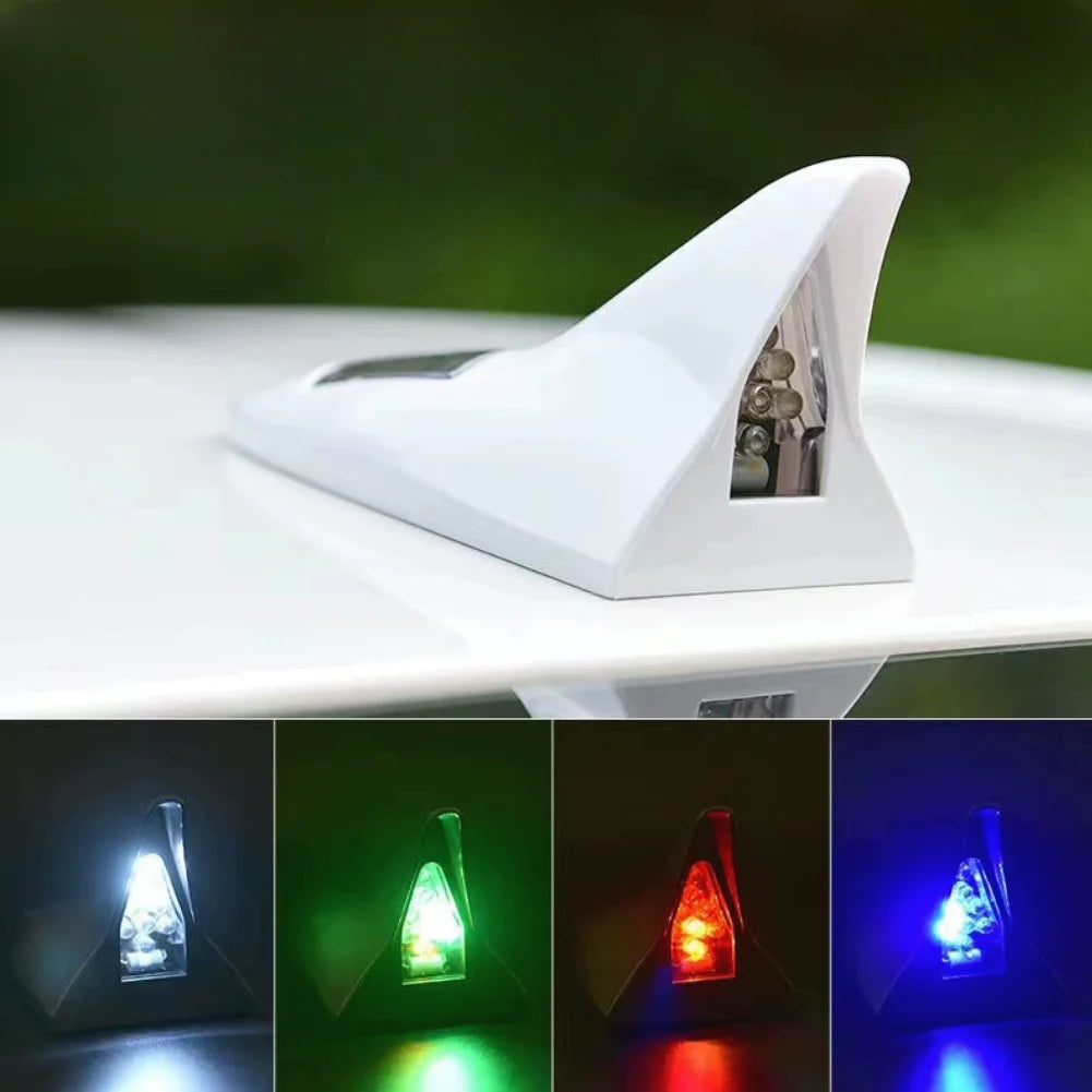 A white solar powered LED warning tail light antenna mounted on a white surface.