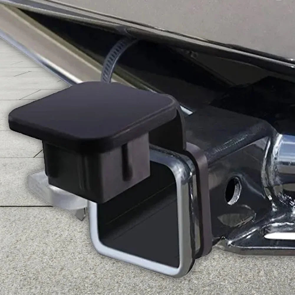A black universal trailer hitch receiver cover is shown attached to a vehicle's hitch, viewed from the side.