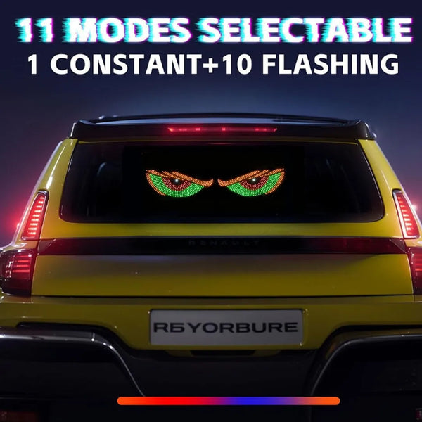 Rear view of a yellow Renault vehicle with an RGB dynamic demon eye light display visible on the trunk.