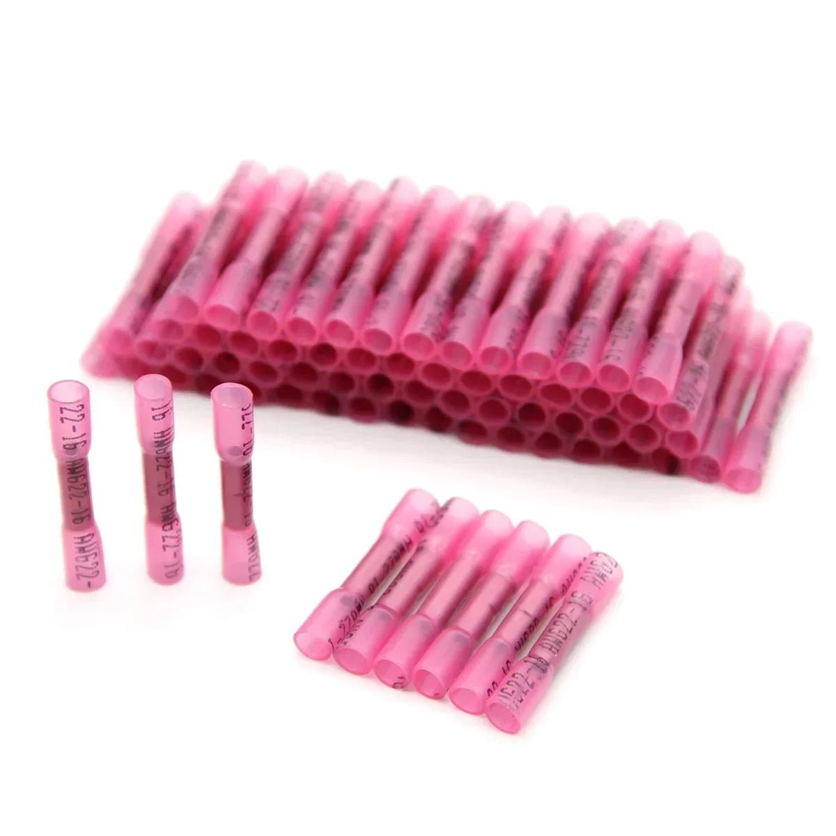 A row of pink durable heat shrink wire connectors arranged in a linear pattern.