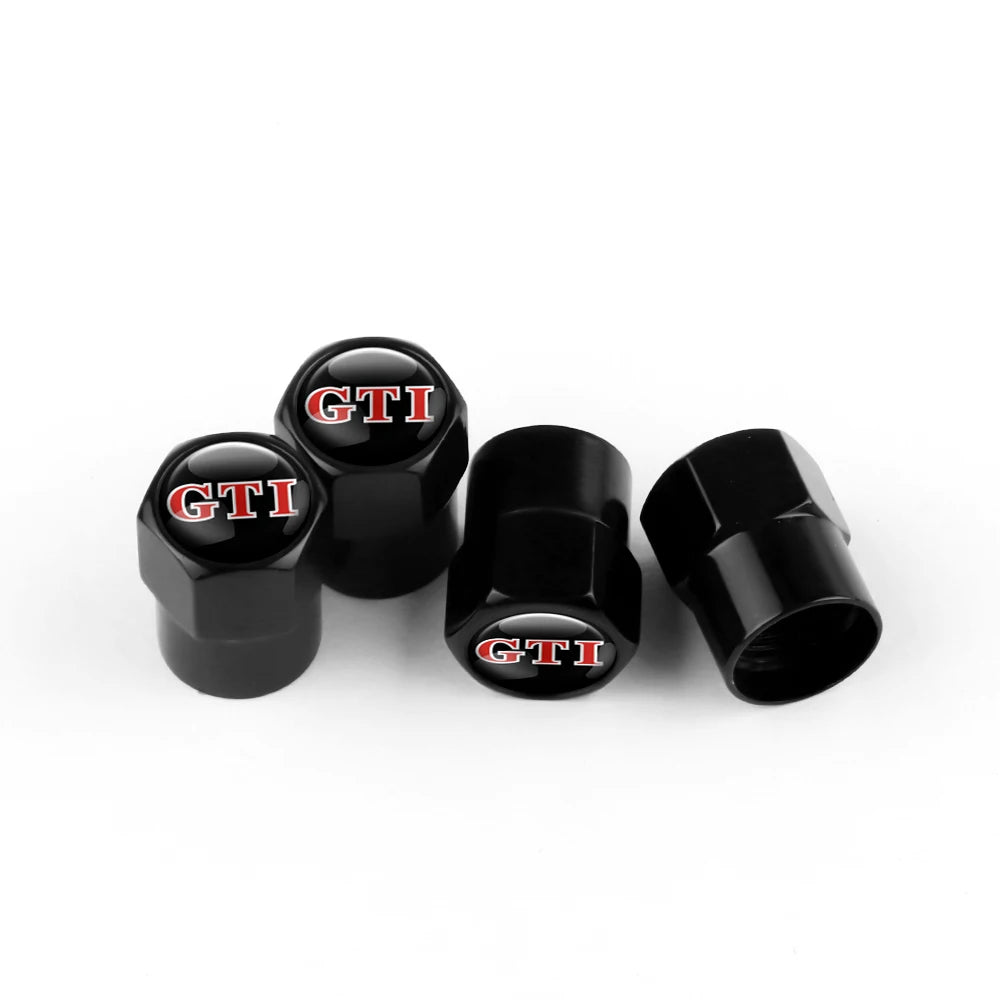 Three black metal tire valve caps with the GTI logo are displayed on a white background.