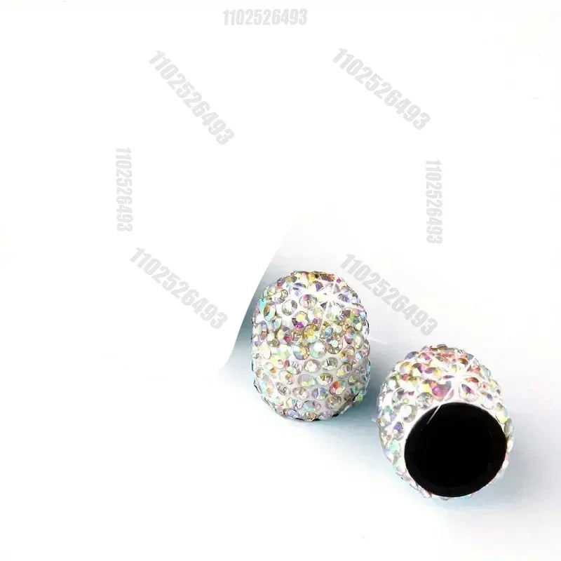A set of crystal diamond finish tire valve caps with a textured, sparkling surface.