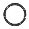 A circular cover decorated with small black rhinestones and clear diamonds.