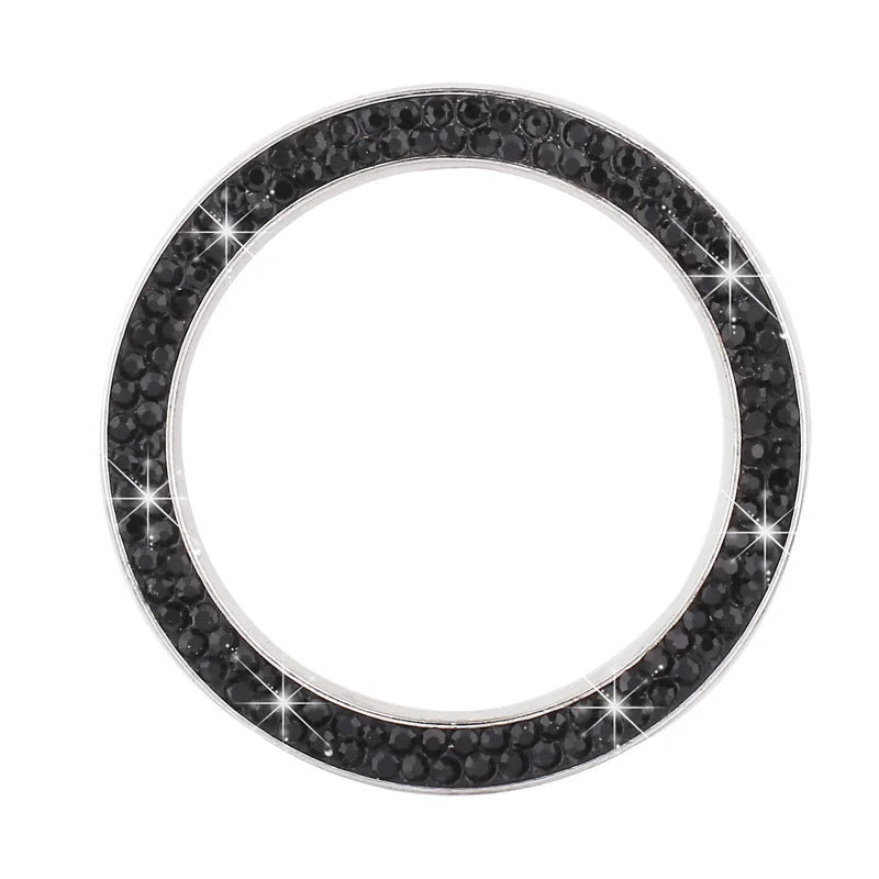 A circular cover decorated with small black rhinestones and clear diamonds.