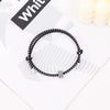 A black heart-shaped fitness tracker bracelet is displayed on a white background.